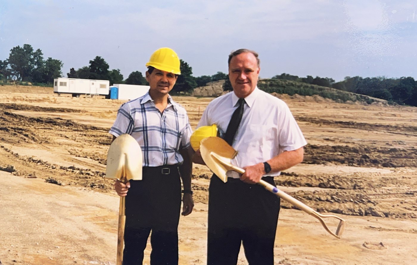 Founders Jim Evans and Tom Schreiner Sr. holding golden shovels at the 1999 groundbreaking of the 1st Ayd headquarters in Elgin, Illinois